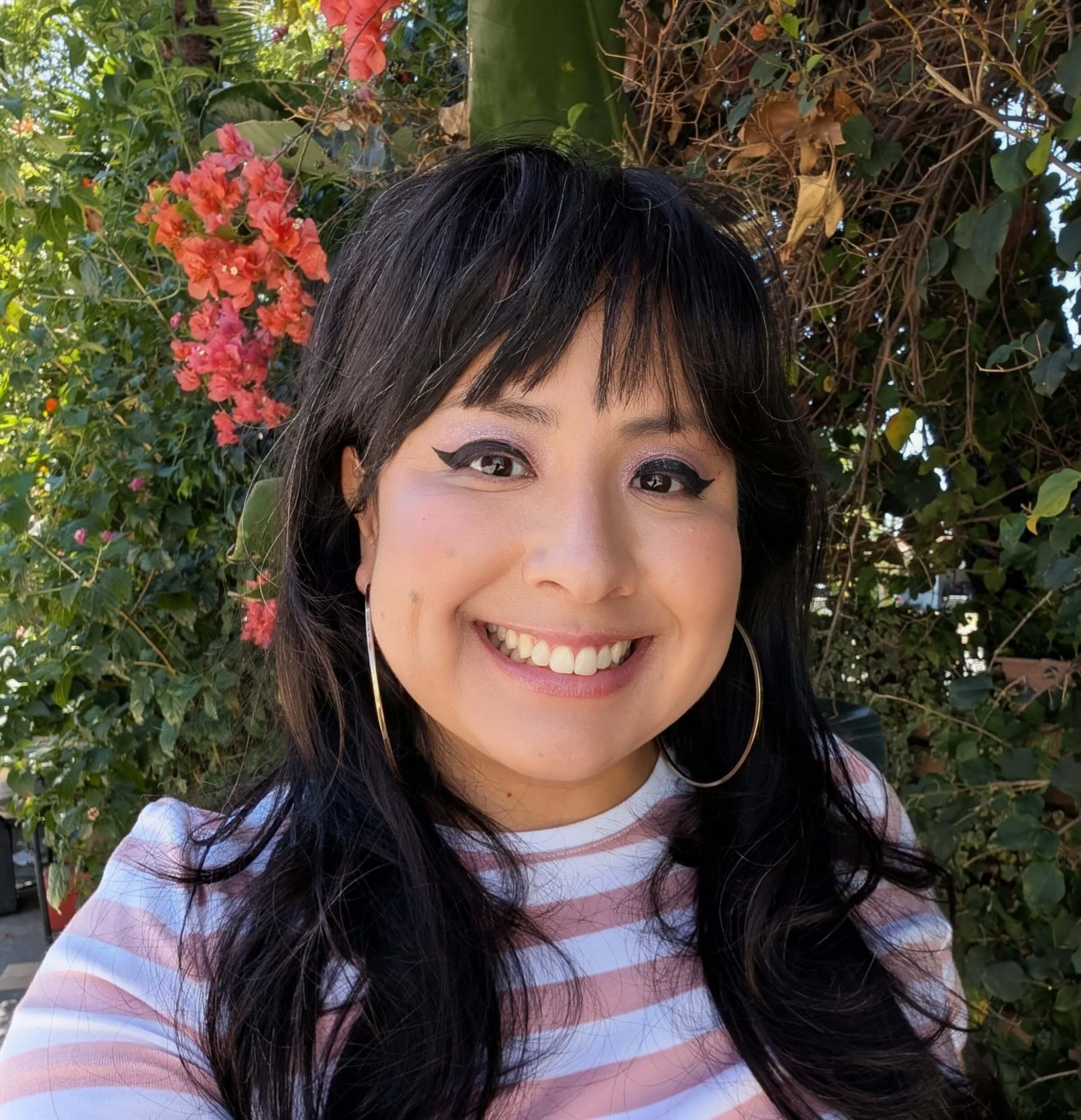 Beatriz smiling with trees in the back