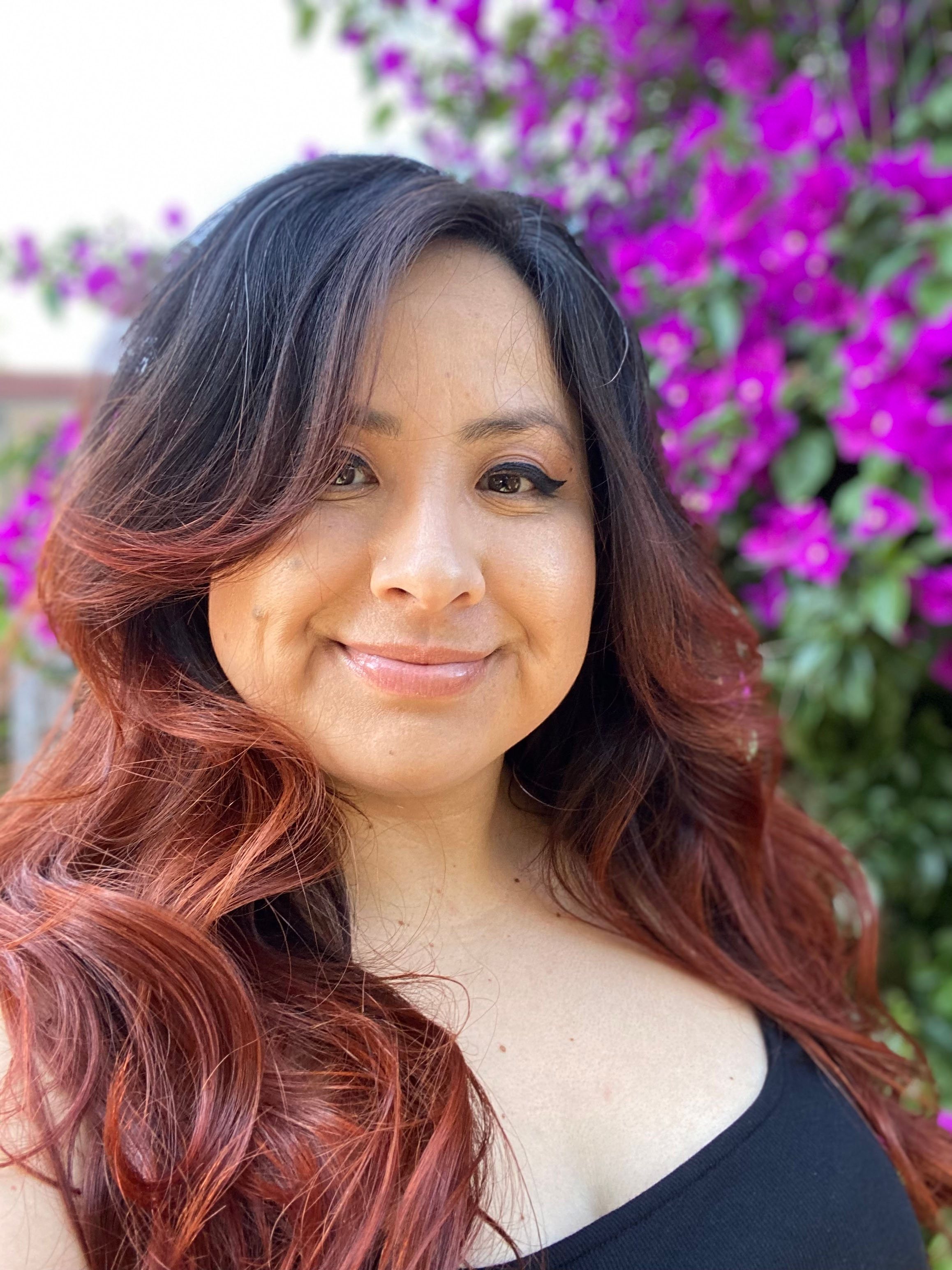 Beatriz with purple flowers in back